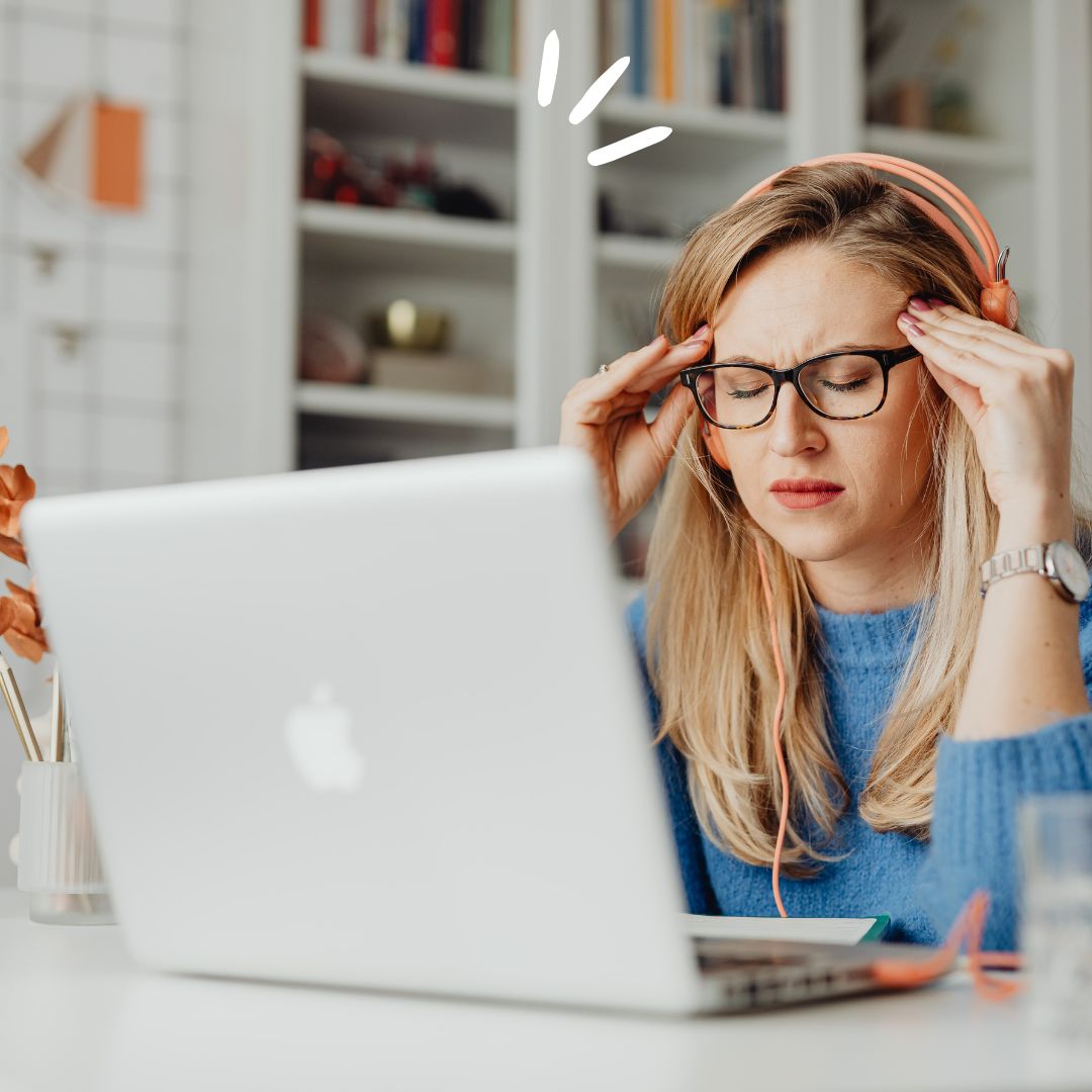 woman having headache using laptop